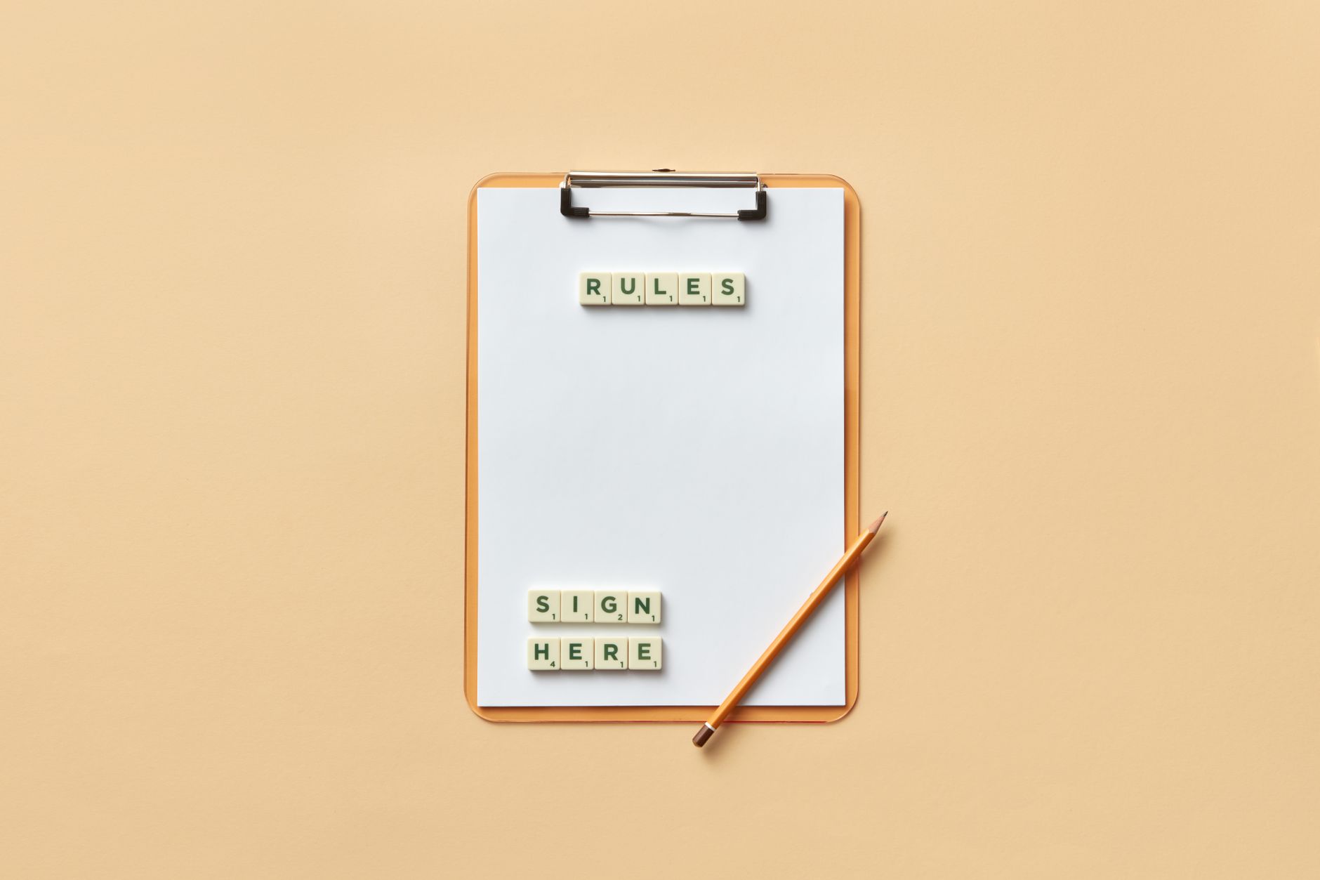 a clipboard with letter tiles spelling rules