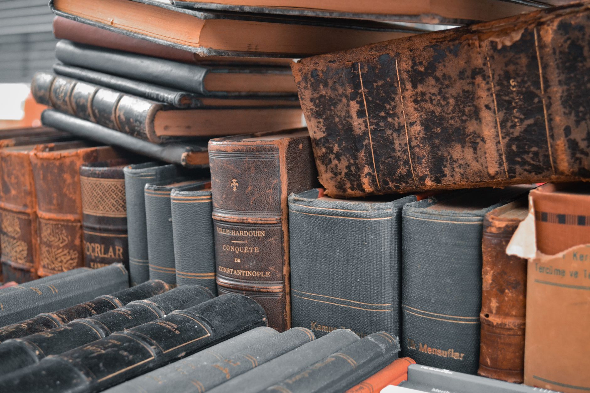 leather bound antique books on a shelf